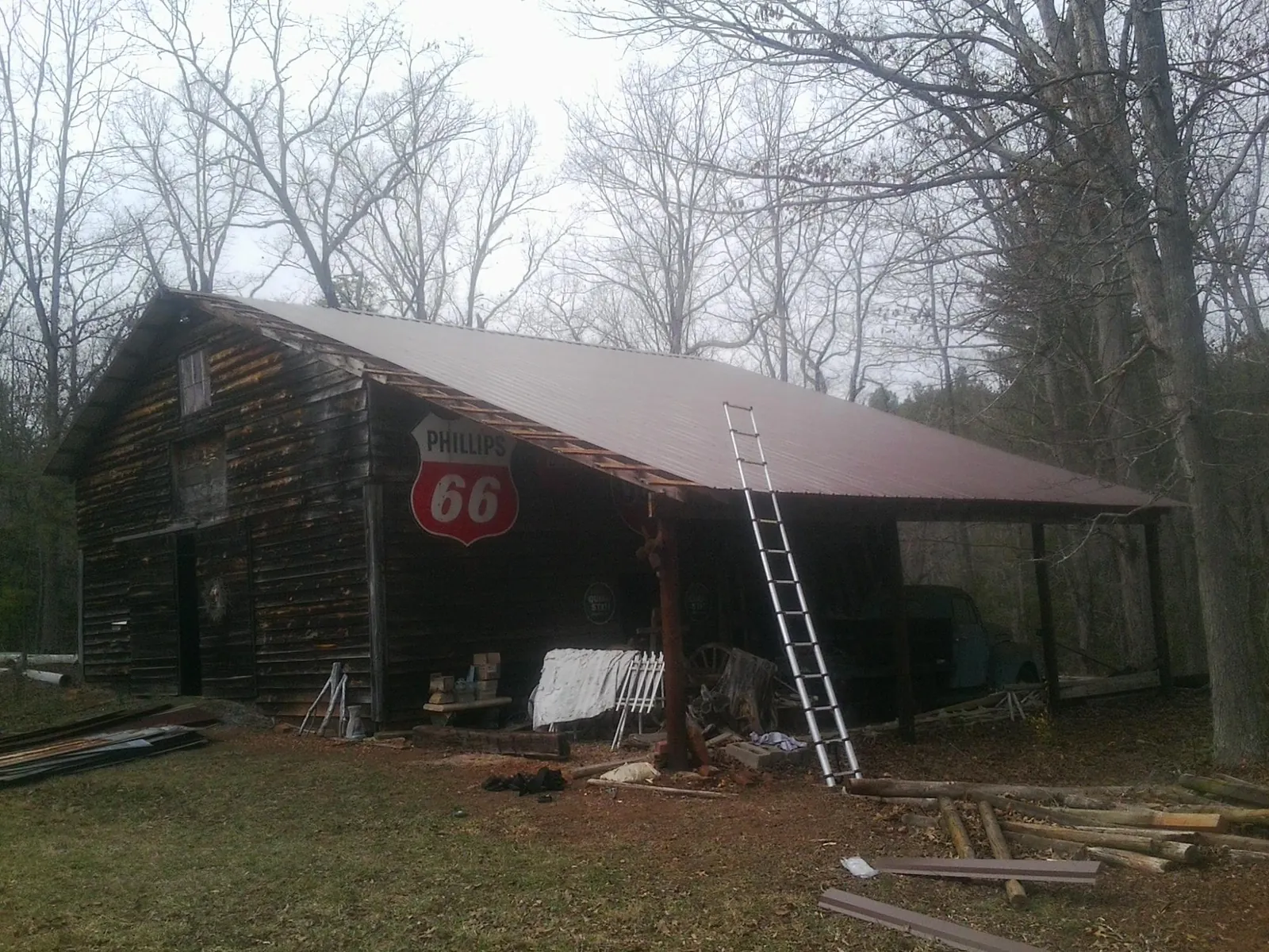 New metal roof on an open sided timber barn with a vintage sign in Whippany