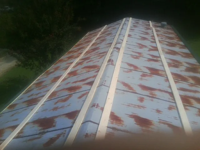Rusted metal roof panels with new wood purlins before replacement — Storm Damage Roof Repair in Whippany by Roofing Brothers