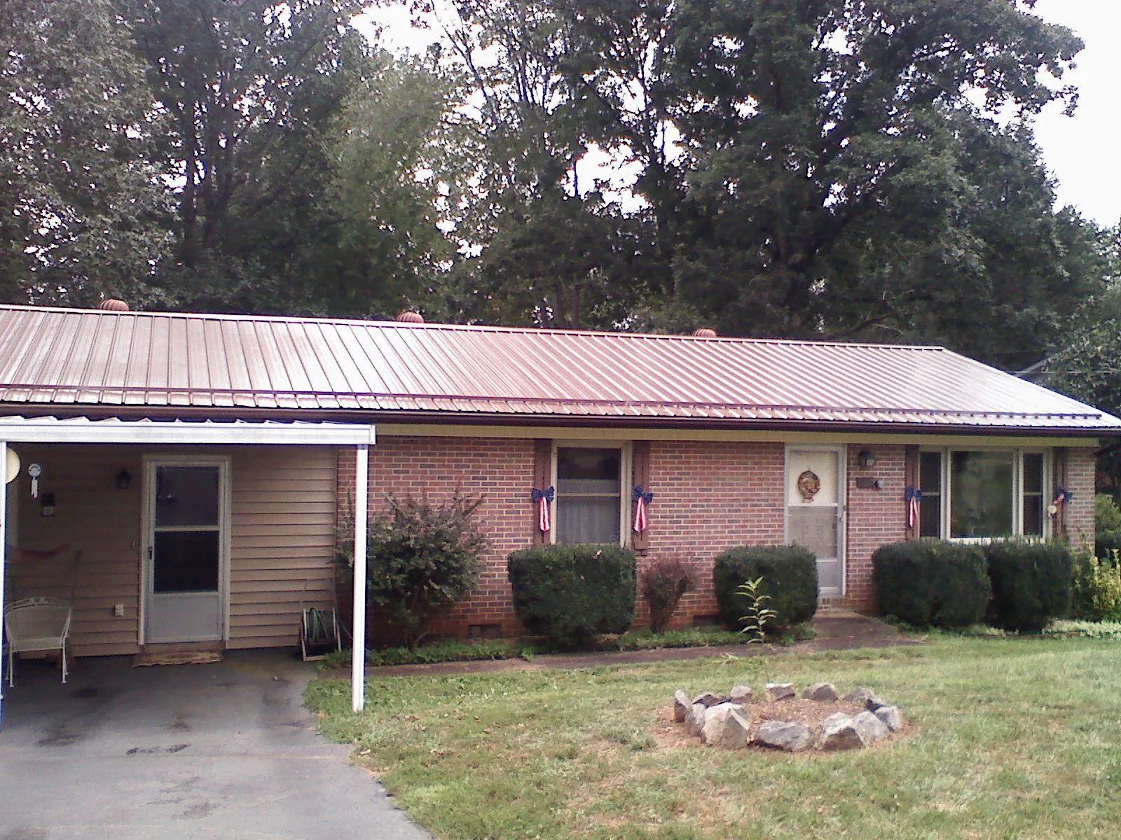 Bronze metal roof and carport on a brick ranch home — Roof Repair work by our crew in Whippany