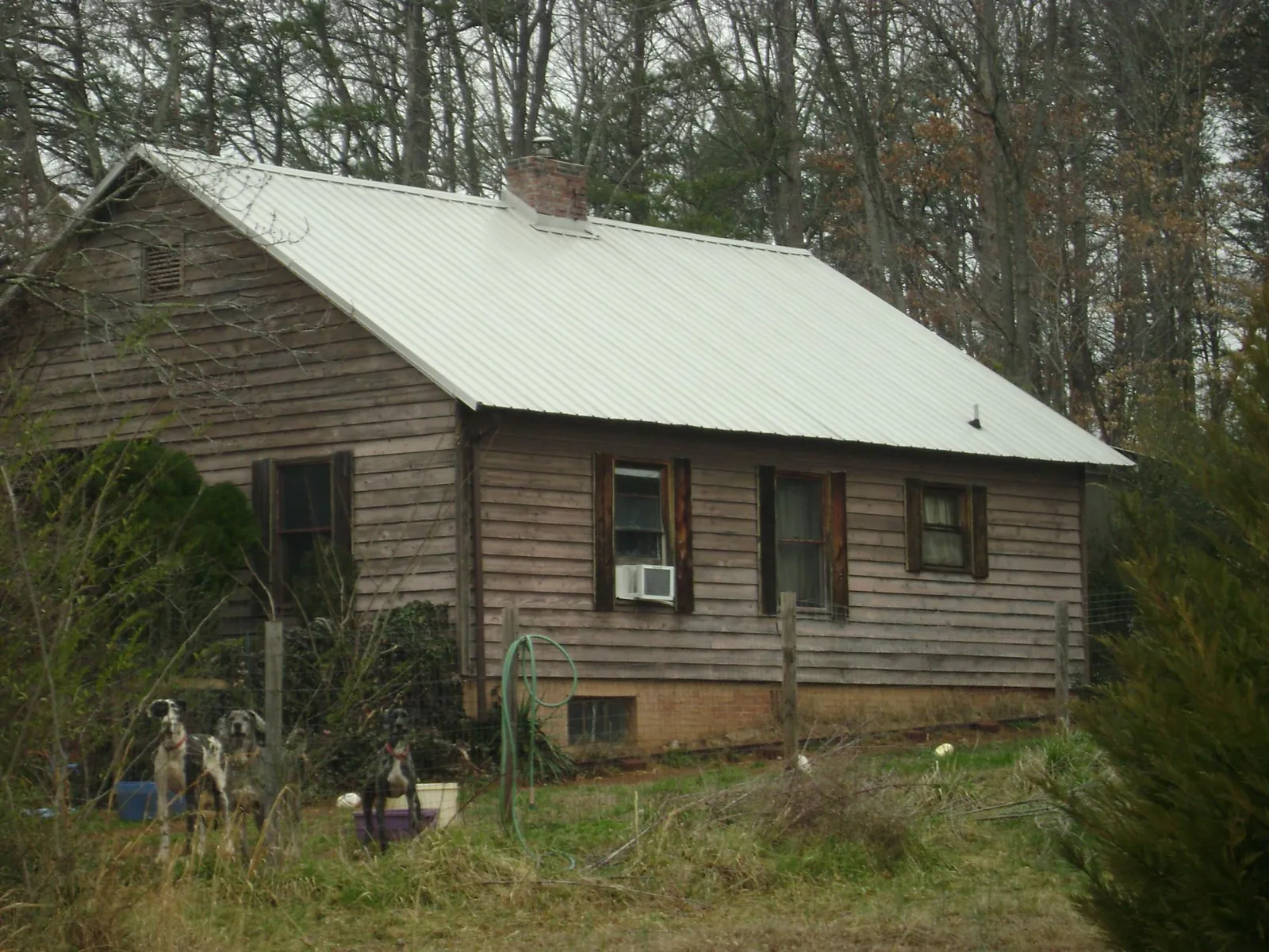 White metal roof on an old wood sided farmhouse, from a Metal Roof Installation job in Whippany